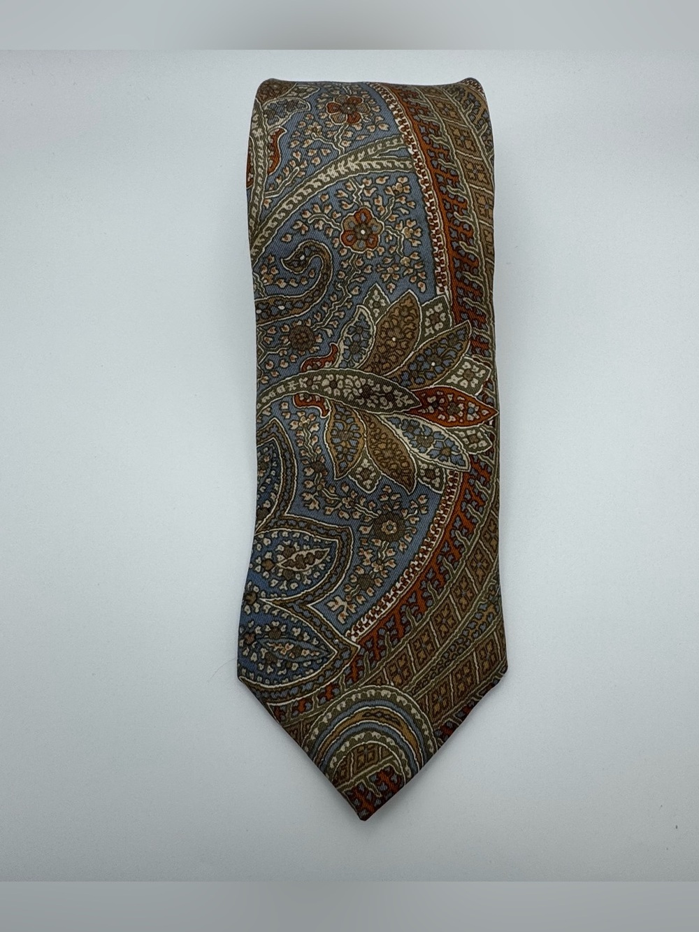 Vintage Michel necktie featuring an intricate paisley pattern in muted colors